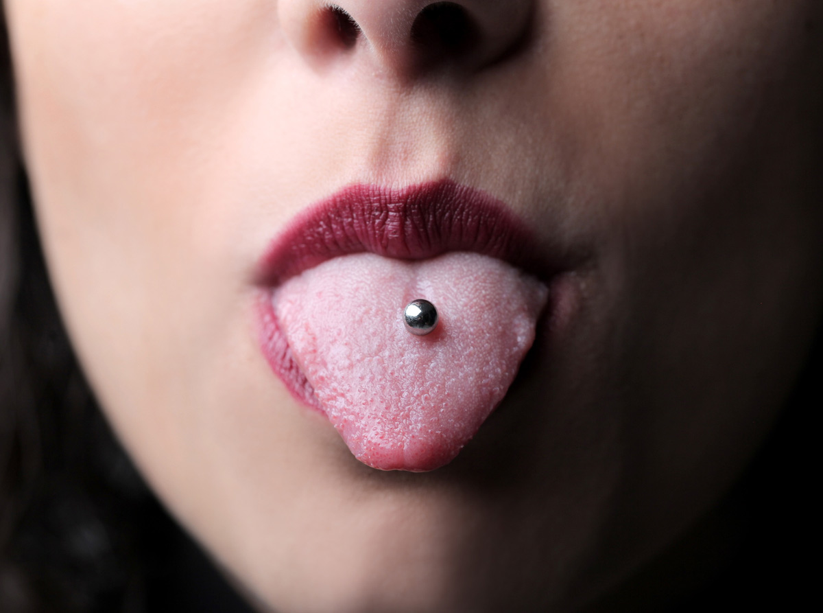 Tongue piercings may be marginally safer with plastic stud material.