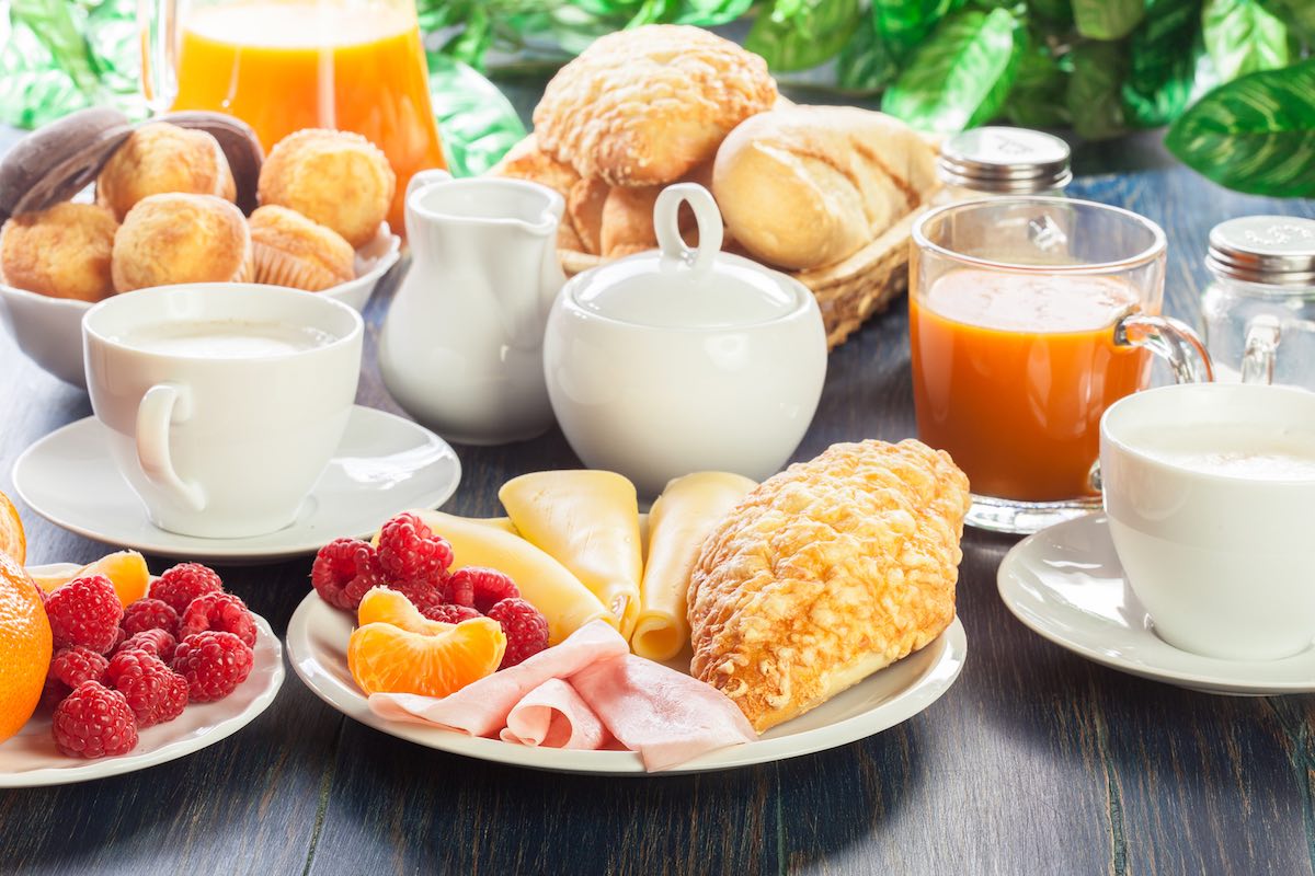 Fresh and continental breakfast table with ham and cheese